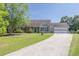 Inviting single-story home featuring a long concrete driveway and a well-maintained lawn at 1490 Twin Manor Dr, Loganville, GA 30052
