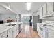Bright kitchen featuring white cabinets, stainless steel appliances, and tile floors at 1490 Twin Manor Dr, Loganville, GA 30052