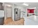 Spacious kitchen with stainless steel fridge and appliances and view into the dining area at 1490 Twin Manor Dr, Loganville, GA 30052