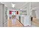 Open concept kitchen with stainless steel appliances, white cabinets, and view to the dining and living areas at 1490 Twin Manor Dr, Loganville, GA 30052