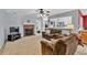 Open-concept living room featuring a brick fireplace and a seamless transition to the kitchen at 1490 Twin Manor Dr, Loganville, GA 30052