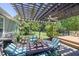 Outdoor patio area with a wooden pergola, comfortable seating, and a grill, perfect for entertaining at 1490 Twin Manor Dr, Loganville, GA 30052