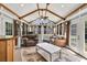 Bright sunroom with vaulted ceilings, ceiling fans, comfortable seating, and natural light from many windows at 1490 Twin Manor Dr, Loganville, GA 30052