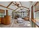 Inviting sunroom with vaulted ceilings, exposed beams, ceiling fans, and comfortable seating area at 1490 Twin Manor Dr, Loganville, GA 30052