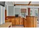 Sunroom wet bar with wooden cabinets, natural light from windows, and built in shelving at 1490 Twin Manor Dr, Loganville, GA 30052