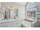 Bathroom with dual sinks, modern fixtures, and a large window above the tub at 2058 Drogheda Ln, Marietta, GA 30066