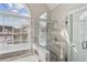 Bathroom featuring a glass shower and a window with neighborhood views at 2058 Drogheda Ln, Marietta, GA 30066