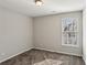 Neutral bedroom with a single window allowing natural light to filter in at 2058 Drogheda Ln, Marietta, GA 30066