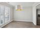 Dining room with hardwood floors, natural light, and modern light fixture adjacent to the kitchen at 2058 Drogheda Ln, Marietta, GA 30066