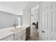 Bright kitchen featuring a farmhouse sink, stainless steel appliances, white cabinets and a view to the living room at 2058 Drogheda Ln, Marietta, GA 30066