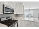 Modern kitchen featuring stainless steel appliances, white countertops and cabinetry, and natural lighting at 2058 Drogheda Ln, Marietta, GA 30066