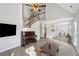 Open-concept living room with high ceilings, a ceiling fan, hardwood floors and a view to the dining room at 2058 Drogheda Ln, Marietta, GA 30066