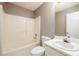 Well-lit bathroom featuring a shower-tub combination, white fixtures, and ample counter space at 3730 Warriors Path, Decatur, GA 30034