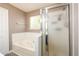 Bathroom features tub and walk in shower with white tiling at 3730 Warriors Path, Decatur, GA 30034