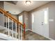 Welcoming entryway features wood-look flooring, a white front door, and a staircase with a wooden railing at 3730 Warriors Path, Decatur, GA 30034