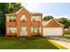Charming brick two-story home with a well-manicured lawn and an attached two-car garage at 3730 Warriors Path, Decatur, GA 30034