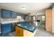 Open kitchen with an island, stainless steel appliances, and blue cabinetry, connecting to the living area at 3730 Warriors Path, Decatur, GA 30034