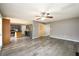 Open living room shows stainless steel appliances in kitchen, hardwood floors, and gray paint at 3730 Warriors Path, Decatur, GA 30034