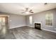 Bright living room features hardwood floors, neutral paint, ceiling fan, and a cozy fireplace at 3730 Warriors Path, Decatur, GA 30034