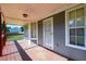 Inviting covered porch showcasing a bay window, secure entry door, and wood flooring at 3730 Warriors Path, Decatur, GA 30034