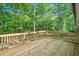 Wood deck with rail overlooks wooded backyard area at 5155 Oakdale Ct, Douglasville, GA 30135