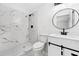 Modern bathroom with marble-look tile, round mirror, and floating vanity at 5155 Oakdale Ct, Douglasville, GA 30135
