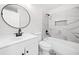 Modern bathroom with marble-look tile, round mirror, and floating vanity at 5155 Oakdale Ct, Douglasville, GA 30135