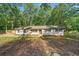 Charming ranch-style home with freshly painted exterior and well-maintained front yard landscaping at 5155 Oakdale Ct, Douglasville, GA 30135