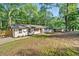 Charming exterior showcasing a well-manicured lawn and lush greenery, providing a picturesque setting for this lovely home at 5155 Oakdale Ct, Douglasville, GA 30135