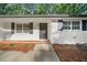 Inviting front entrance featuring a stylish door, black shutters, and well-maintained landscaping, creating curb appeal at 5155 Oakdale Ct, Douglasville, GA 30135