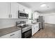 Updated kitchen with stainless steel appliances, granite countertops, and wood look flooring at 5155 Oakdale Ct, Douglasville, GA 30135