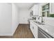 Kitchen with stainless steel appliances, white cabinets, granite countertops, and wood floors at 5155 Oakdale Ct, Douglasville, GA 30135