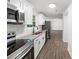 Bright kitchen with stainless steel appliances, granite countertops, white cabinets, and new flooring at 5155 Oakdale Ct, Douglasville, GA 30135