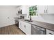 Modern kitchen featuring white cabinets, granite countertops, stainless steel appliances and wood floors at 5155 Oakdale Ct, Douglasville, GA 30135