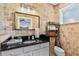 Bathroom with stone-tiled walls, granite countertops, and a decorative vanity at 571 Morgan Ne St, Atlanta, GA 30308