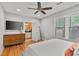 Bright bedroom featuring hardwood floors, a large dresser, and an ensuite bathroom at 571 Morgan Ne St, Atlanta, GA 30308