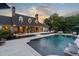 Backyard view of the home with large pool and lounge area creates an outdoor oasis for entertaining at 7255 Old Rico Rd, Chattahoochee Hills, GA 30268