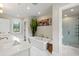 Elegant bathroom featuring a soaking tub, separate shower, and double vanity at 7255 Old Rico Rd, Chattahoochee Hills, GA 30268