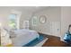 Cozy bedroom featuring hardwood floors, built-in shelving, and a guitar at 7255 Old Rico Rd, Chattahoochee Hills, GA 30268