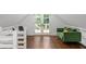 Bright bonus room with hardwood floors, a comfortable green sofa, and walkout at 7255 Old Rico Rd, Chattahoochee Hills, GA 30268