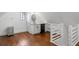 Bonus room featuring hardwood floors, a kitchenette, and staircase at 7255 Old Rico Rd, Chattahoochee Hills, GA 30268
