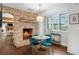 Charming breakfast area with a brick fireplace, a round table, stylish chairs, and windows to outside at 7255 Old Rico Rd, Chattahoochee Hills, GA 30268