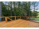 Wooden deck overlooking wooded backyard provides an ideal outdoor relaxation and entertainment area at 7255 Old Rico Rd, Chattahoochee Hills, GA 30268