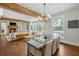 Open floor plan with wood beam, dining table, fireplace, and doors that let in plenty of natural light at 7255 Old Rico Rd, Chattahoochee Hills, GA 30268