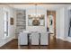 Elegant dining room with a chandelier, large mirror, brick archway, and access to other rooms at 7255 Old Rico Rd, Chattahoochee Hills, GA 30268