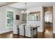 Inviting dining area with wood floors, a chandelier, and a glimpse into the adjoining kitchen space at 7255 Old Rico Rd, Chattahoochee Hills, GA 30268
