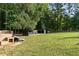 A large fenced dog run with play structures, offering a safe and fun outdoor space for pets at 7255 Old Rico Rd, Chattahoochee Hills, GA 30268