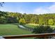 Long driveway, lined with mature trees, leads to an estate and creates an idyllic country setting at 7255 Old Rico Rd, Chattahoochee Hills, GA 30268