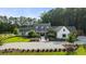An impressive country home with a circular driveway, set among mature trees at 7255 Old Rico Rd, Chattahoochee Hills, GA 30268