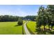 A long, winding driveway leads to this secluded home on sprawling green acreage at 7255 Old Rico Rd, Chattahoochee Hills, GA 30268
